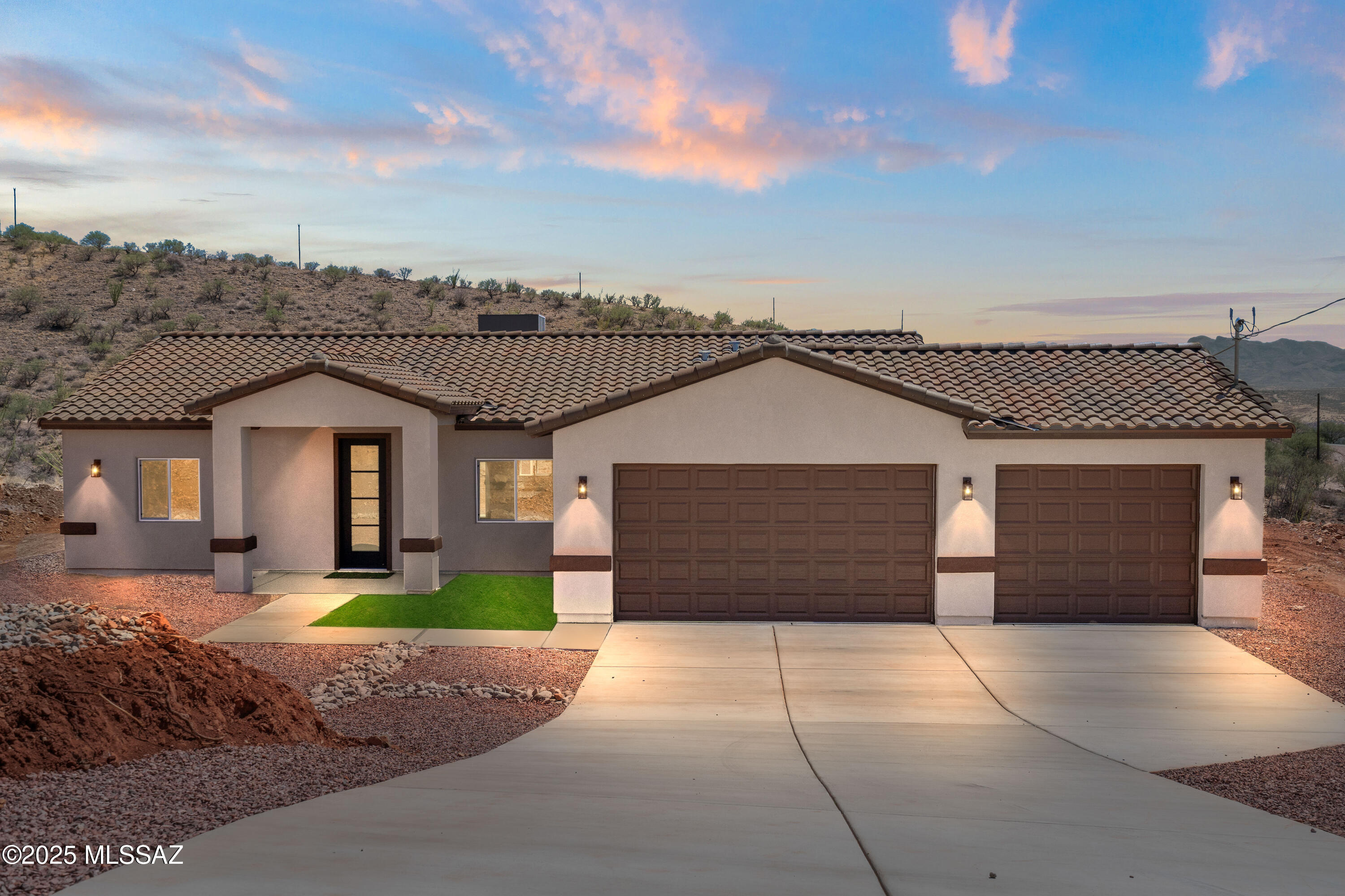 1667 Ave Calamar Rio Rico, AZ 85648 - Photo 1 of 33 a front view of a house with a yard and garage