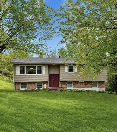 a view of a house with a backyard
