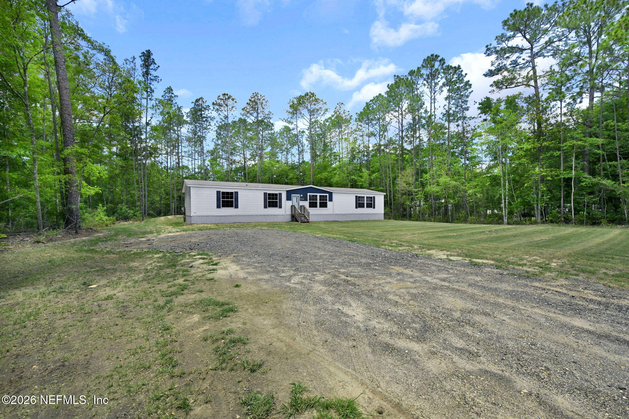 540783 Lem Turner Road Callahan, FL 32011 - Photo 2 of 36 a house view with a garden space