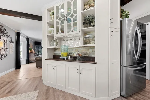 a kitchen with stainless steel appliances granite countertop a refrigerator and a stove top oven