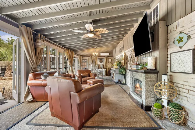 a living room with fireplace furniture and a flat screen tv