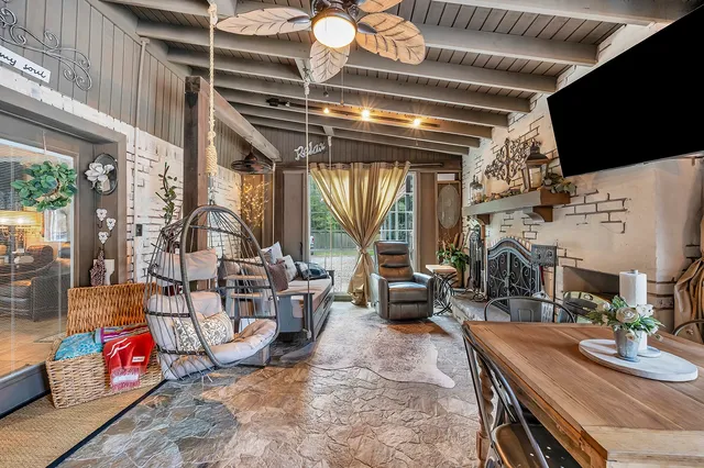 a living room with fireplace furniture and a flat screen tv