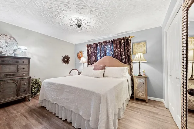 a bedroom with a bed and a chandelier