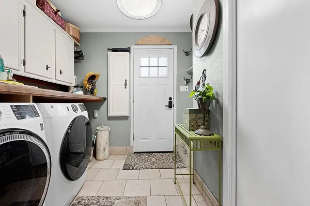 a utility room with closet a washer and dryer