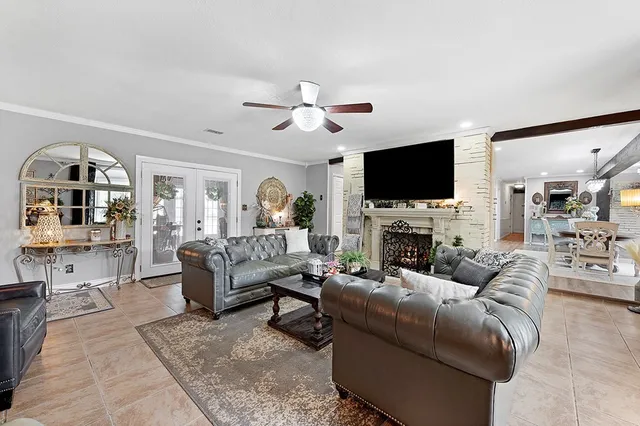 a living room with furniture a fireplace and a flat screen tv