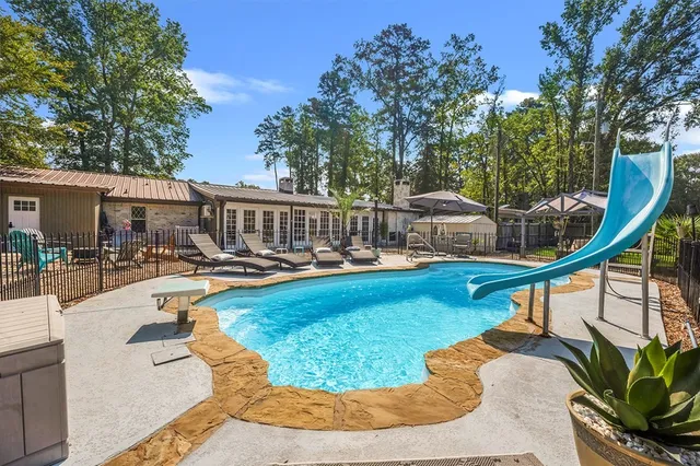 a view of a swimming pool with a lounge chair