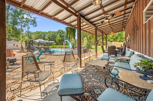 a building outdoor space with patio furniture and potted plants