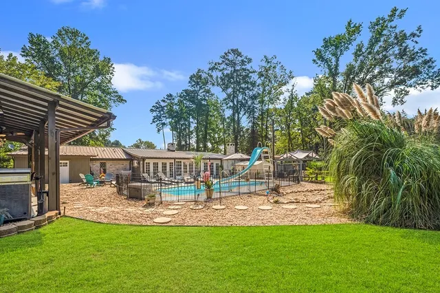 a view of a house with swimming pool and sitting area