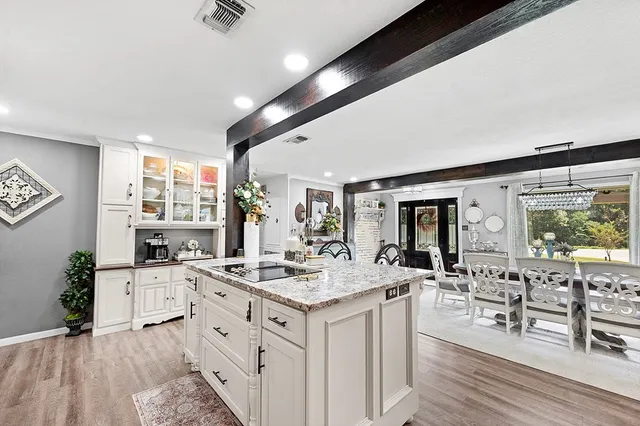 a kitchen with sink stove and cabinets