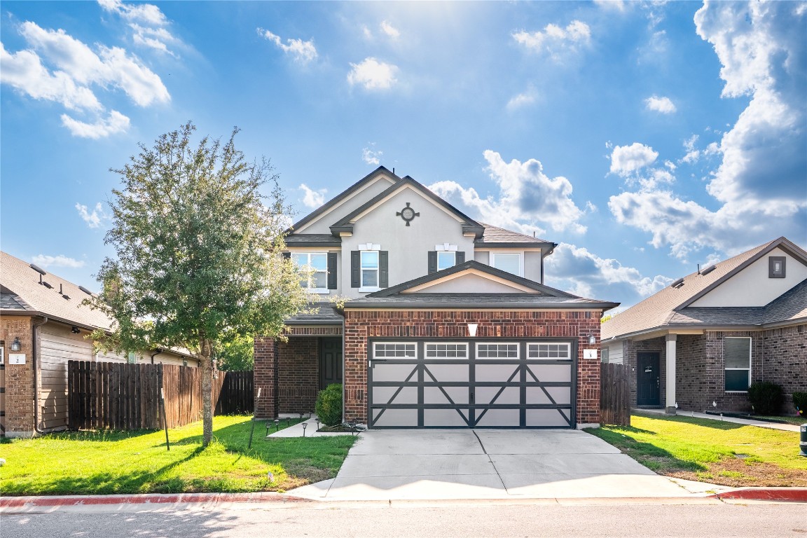 2950 East Old Settlers Boulevard, Unit 3 Round Rock, TX 78665 - Photo 1 of 28 a front view of a house with a yard