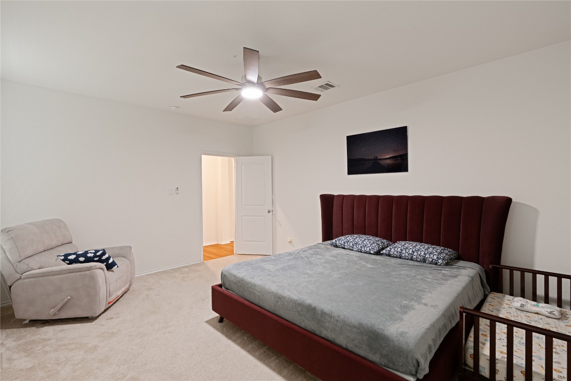 2950 East Old Settlers Boulevard, Unit 3 Round Rock, TX 78665 - Photo 11 of 28 a bedroom with a bed and a flat screen tv