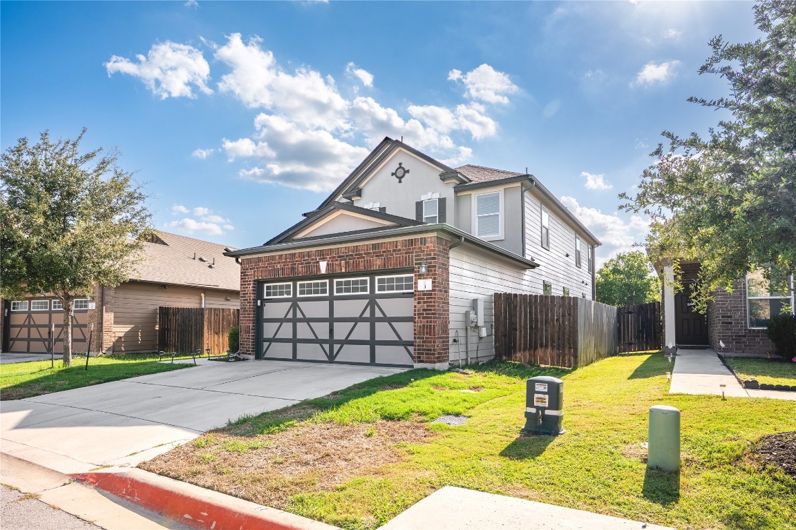 2950 East Old Settlers Boulevard, Unit 3 Round Rock, TX 78665 - Photo 12 of 28 a front view of a house with a yard