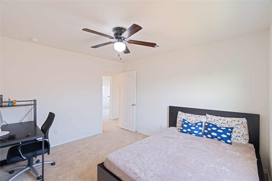 2950 East Old Settlers Boulevard, Unit 3 Round Rock, TX 78665 - Photo 20 of 28 a bedroom with a bed and a desk
