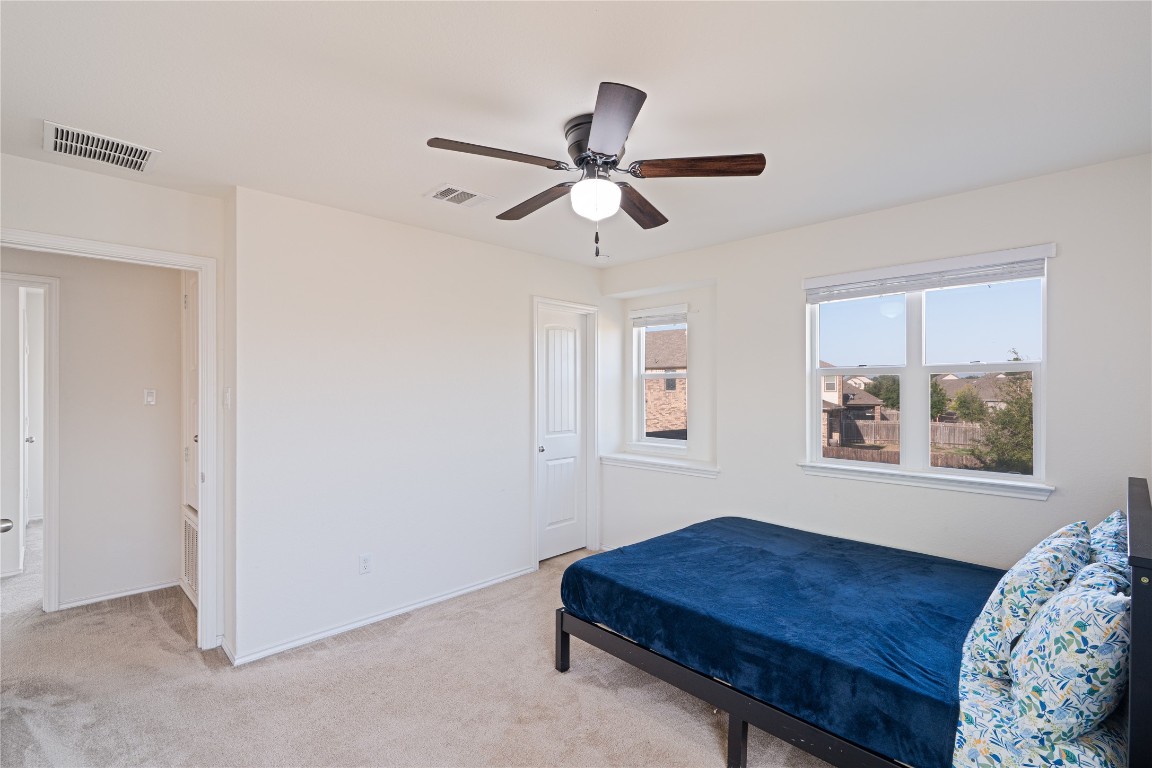 2950 East Old Settlers Boulevard, Unit 3 Round Rock, TX 78665 - Photo 22 of 28 a living room with a bed furniture and a window