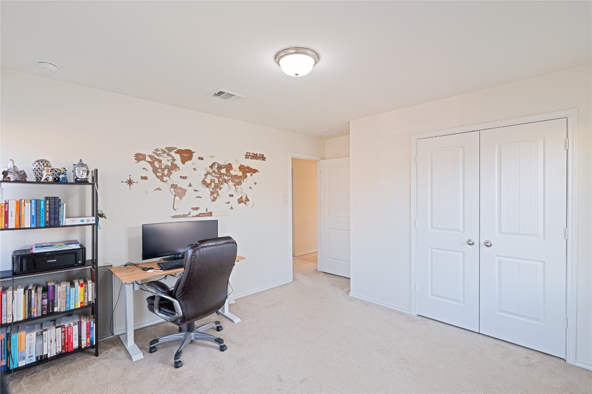 2950 East Old Settlers Boulevard, Unit 3 Round Rock, TX 78665 - Photo 24 of 28 a view of a workspace with furniture and a book shelf