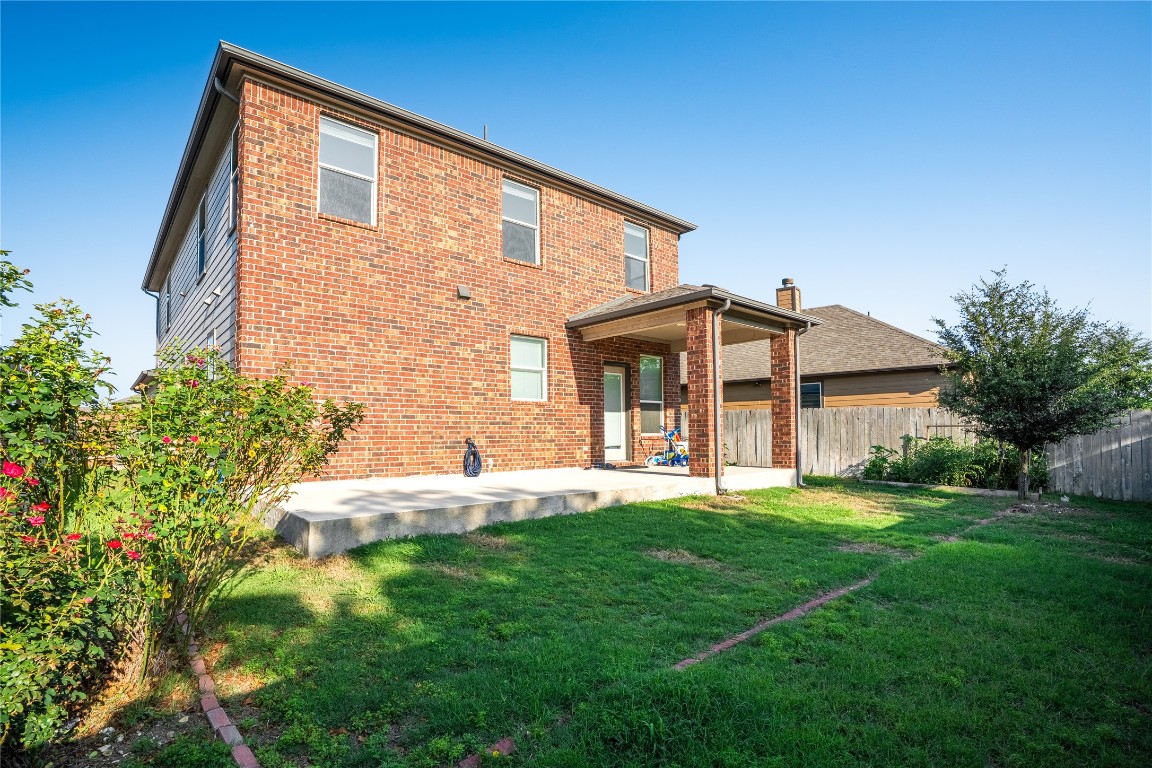 2950 East Old Settlers Boulevard, Unit 3 Round Rock, TX 78665 - Photo 26 of 28 a front view of a house with a yard and trees