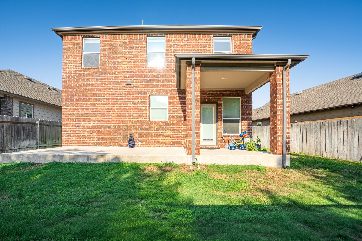 2950 East Old Settlers Boulevard, Unit 3 Round Rock, TX 78665 - Photo 27 of 28 a front view of a house with a yard and garage