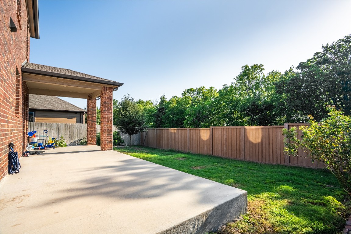 2950 East Old Settlers Boulevard, Unit 3 Round Rock, TX 78665 - Photo 5 of 28 a view of a backyard with large trees and wooden fence