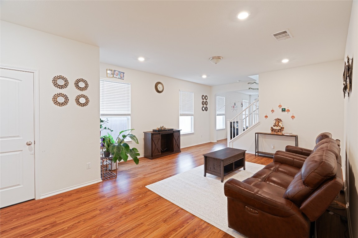 2950 East Old Settlers Boulevard, Unit 3 Round Rock, TX 78665 - Photo 9 of 28 a living room with furniture and wooden floor