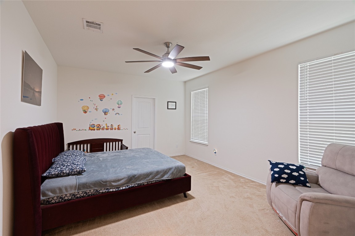 2950 East Old Settlers Boulevard, Unit 3 Round Rock, TX 78665 - Photo 10 of 28 a bedroom with a bed and a couch
