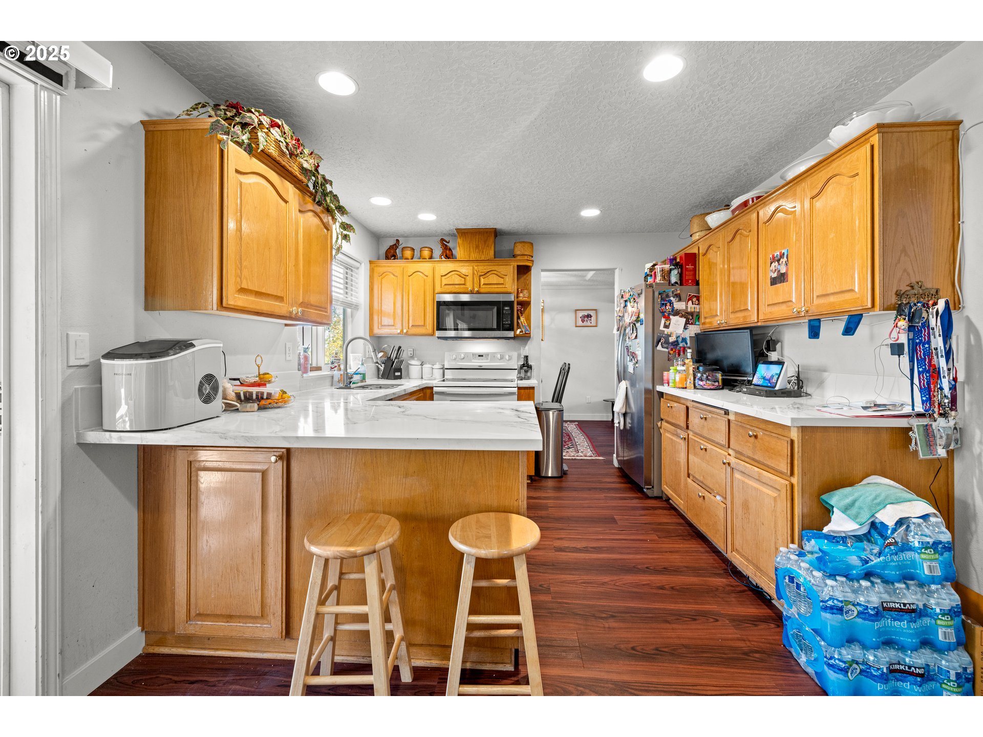 4235 Southeast Anderegg Loop Portland, OR 97236 - Photo 14 of 37 a kitchen with stainless steel appliances kitchen island granite countertop a sink and cabinets