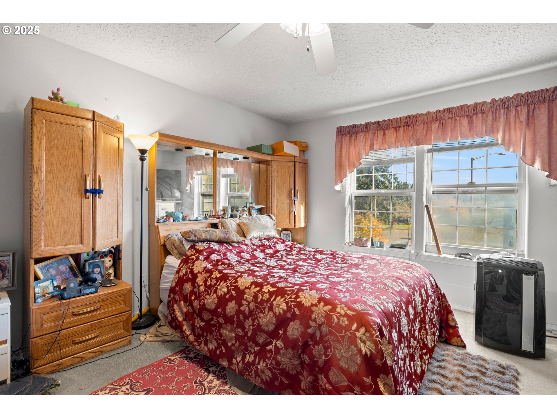 4235 Southeast Anderegg Loop Portland, OR 97236 - Photo 22 of 37 a bedroom with a bed and a large window