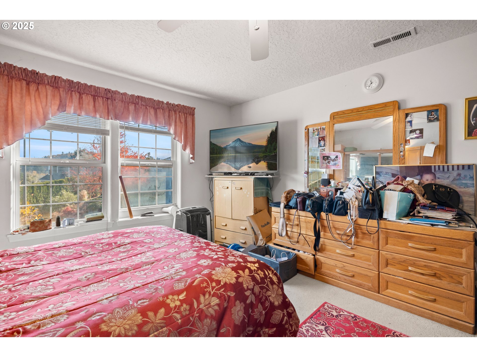 4235 Southeast Anderegg Loop Portland, OR 97236 - Photo 23 of 37 a bedroom with a bed and large windows