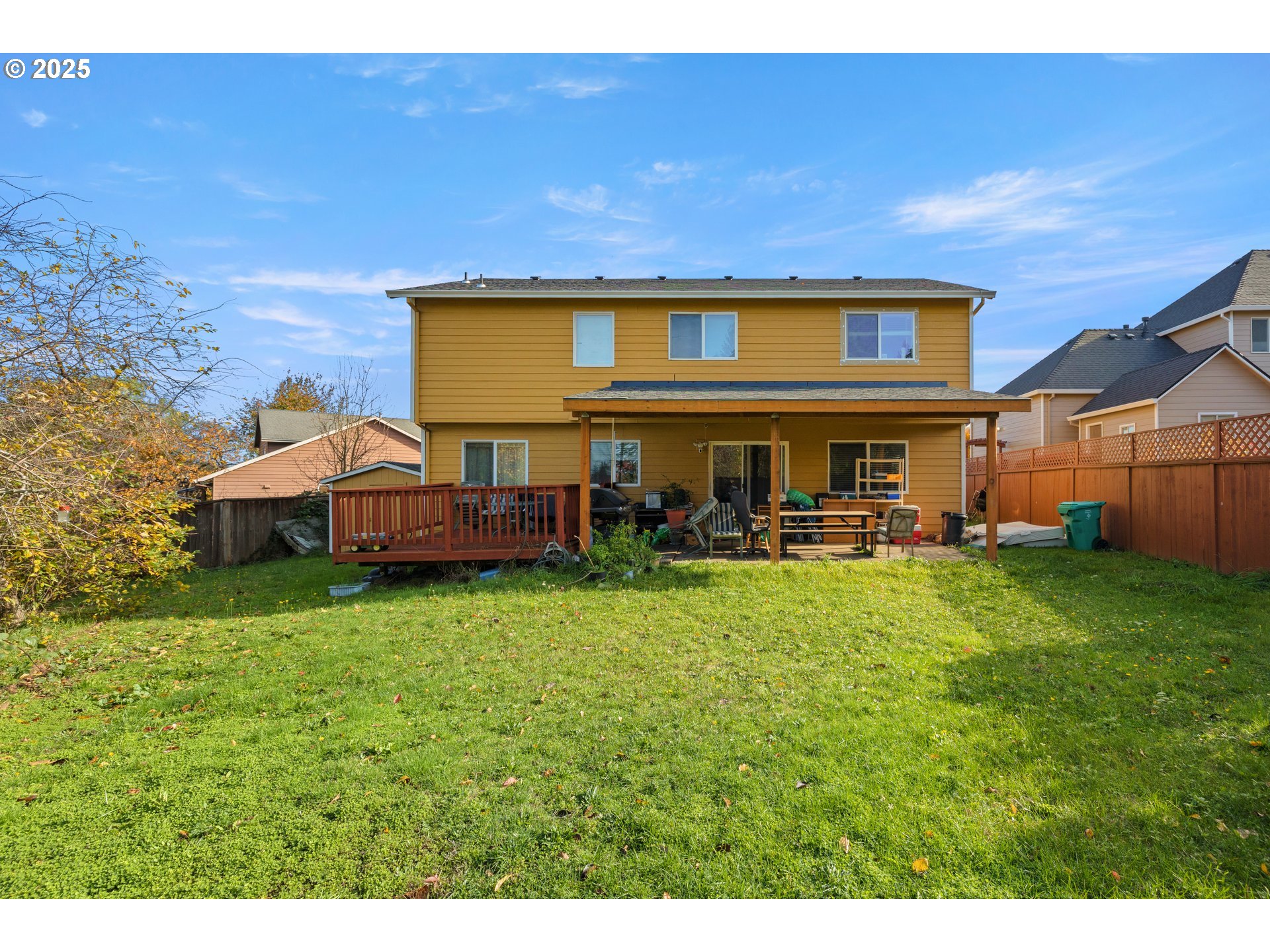 4235 Southeast Anderegg Loop Portland, OR 97236 - Photo 28 of 37 a backyard of a house with table and chairs