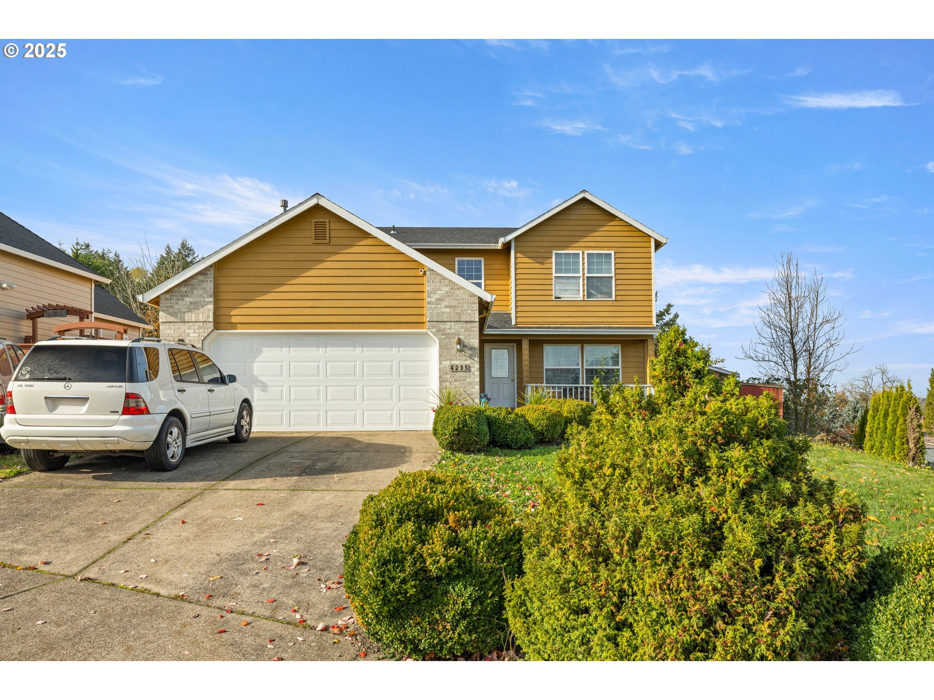 4235 Southeast Anderegg Loop Portland, OR 97236 - Photo 3 of 37 a front view of a house with a yard and garage