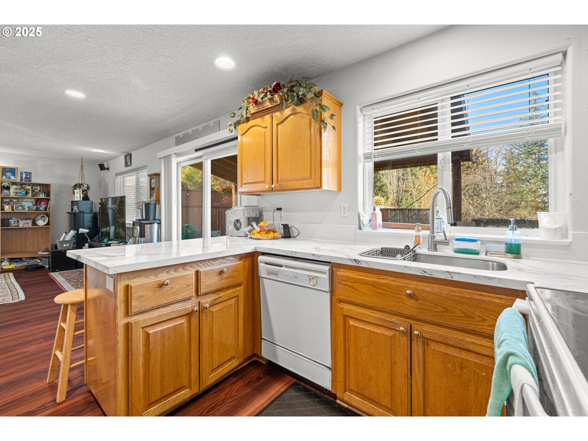 4235 Southeast Anderegg Loop Portland, OR 97236 - Photo 10 of 37 a kitchen with a sink cabinets appliances and a large window