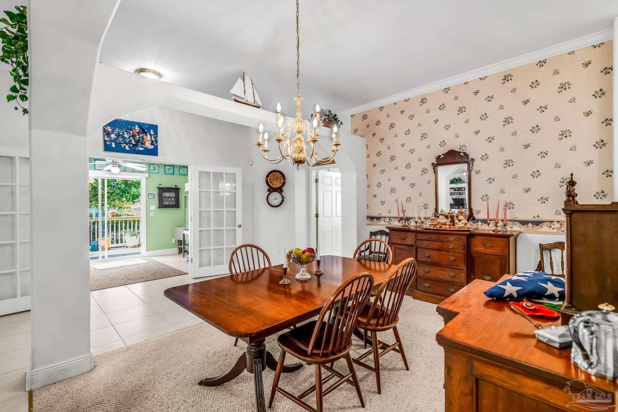 10149 Bittern Drive Pensacola, FL 32507 - Photo 13 of 56 a view of a dining room with furniture and chandelier