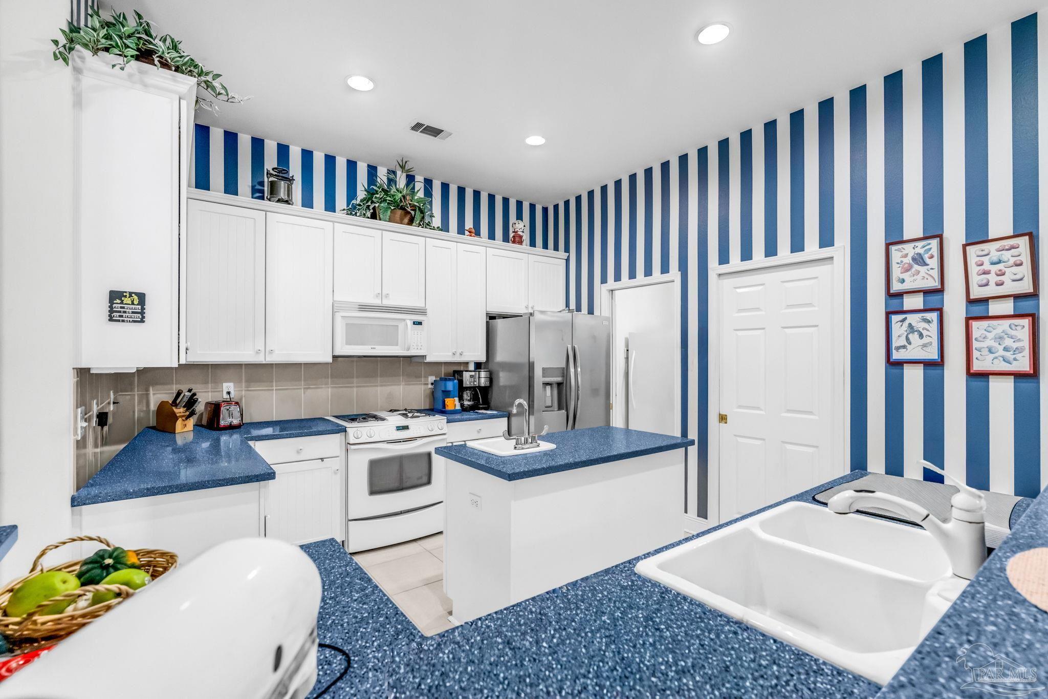 10149 Bittern Drive Pensacola, FL 32507 - Photo 19 of 56 a kitchen with a refrigerator and a stove top oven