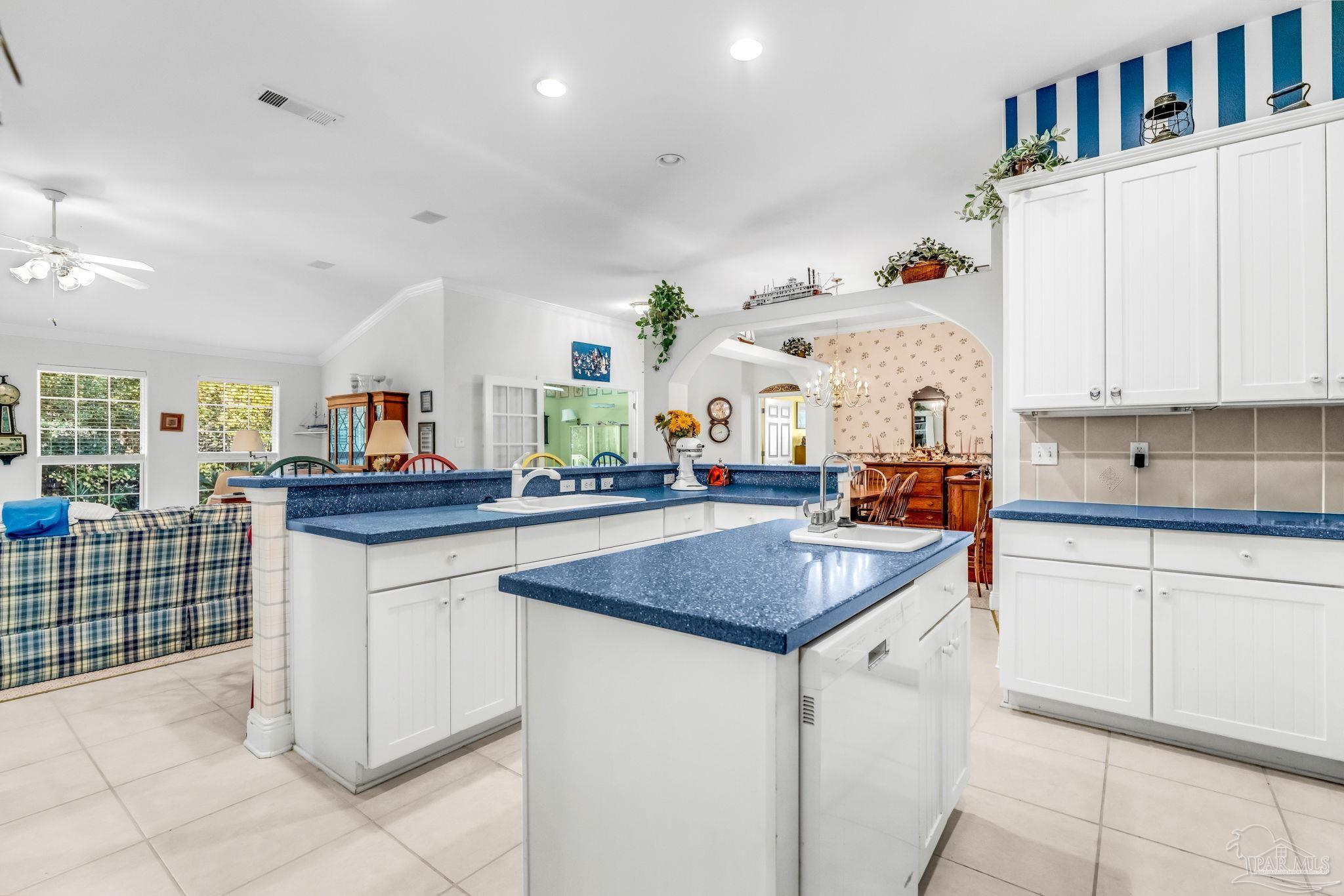 10149 Bittern Drive Pensacola, FL 32507 - Photo 20 of 56 a kitchen with stainless steel appliances granite countertop a sink and cabinets