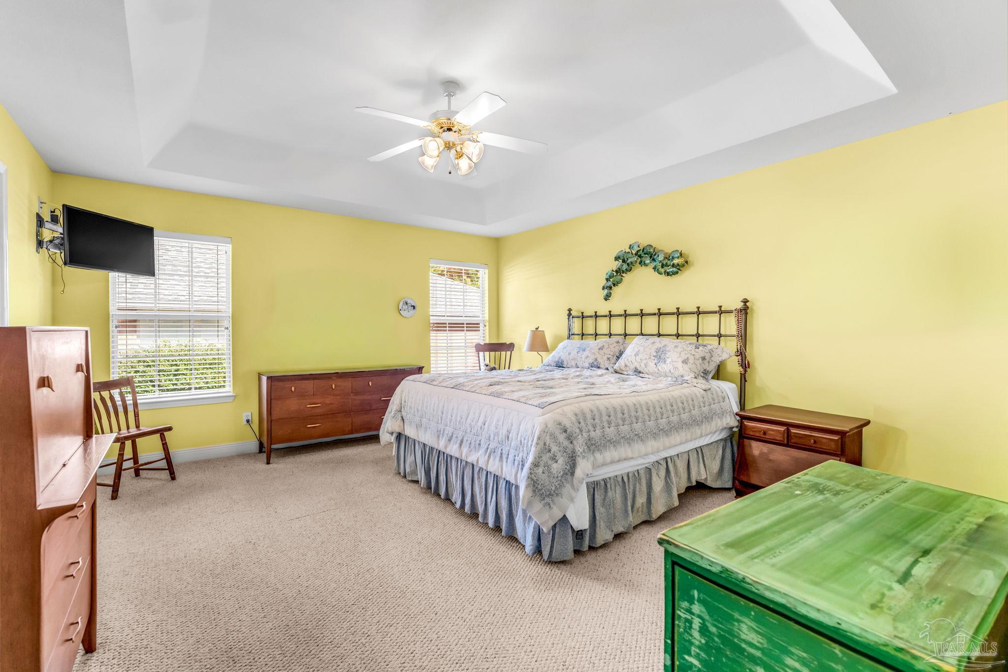 10149 Bittern Drive Pensacola, FL 32507 - Photo 23 of 56 a bedroom with a bed and a chandelier