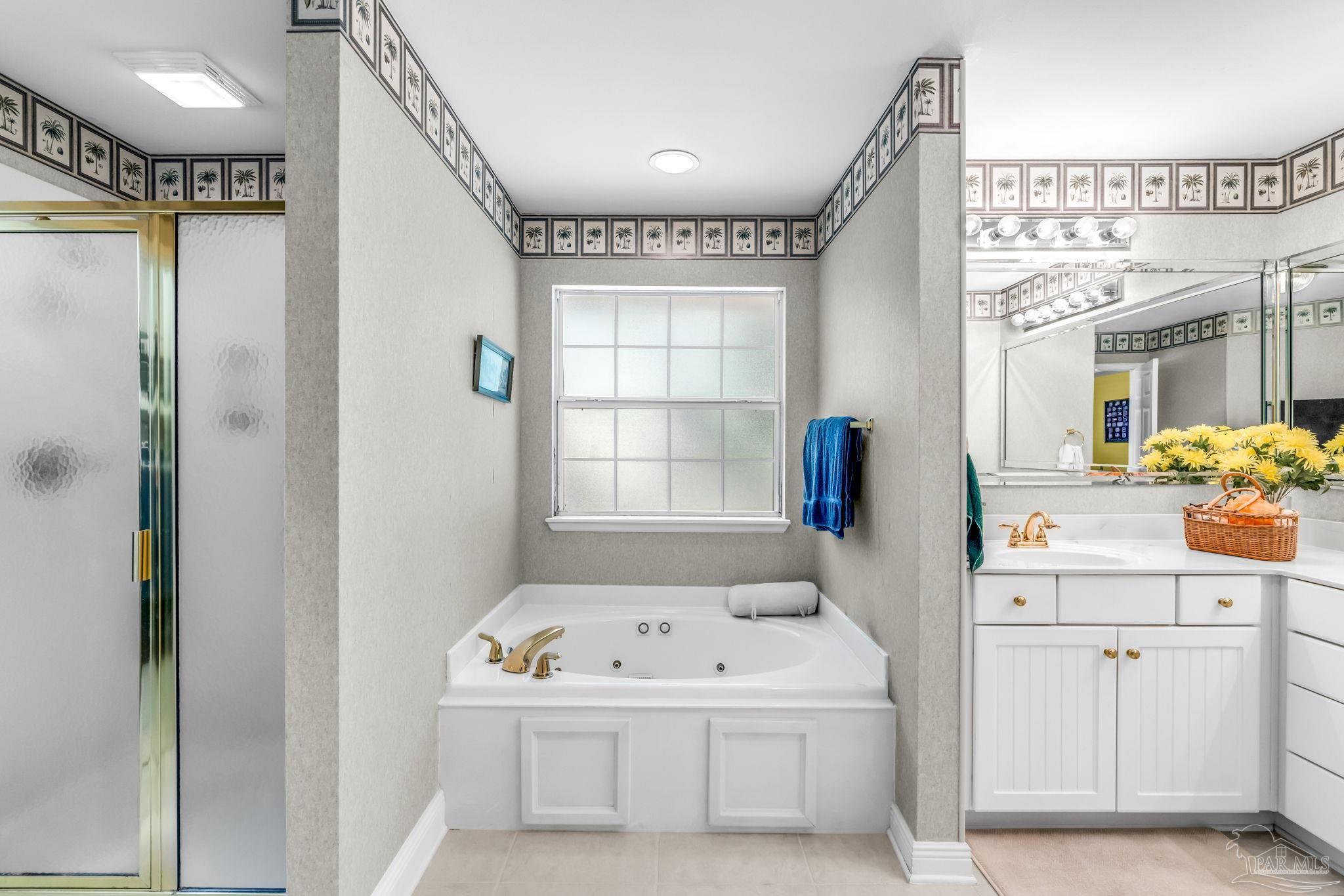 10149 Bittern Drive Pensacola, FL 32507 - Photo 25 of 56 a bathroom with a sink a mirror and a shower