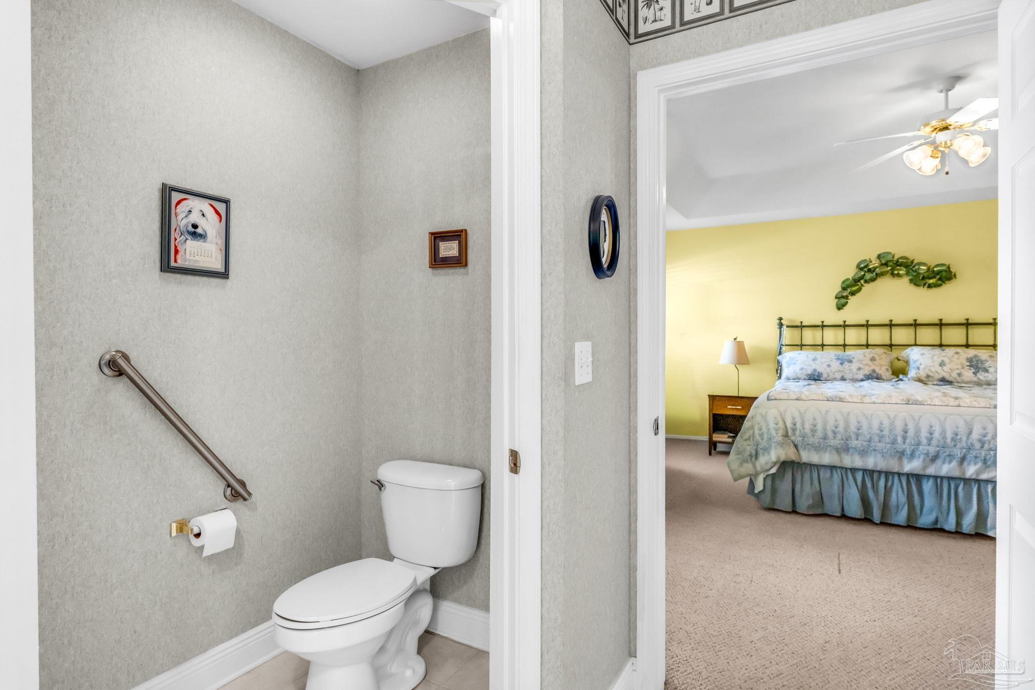 10149 Bittern Drive Pensacola, FL 32507 - Photo 27 of 56 a bedroom with a bed and a view of bathroom
