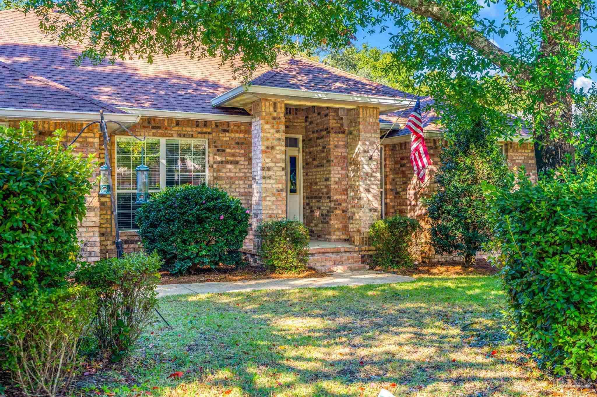 10149 Bittern Drive Pensacola, FL 32507 - Photo 3 of 56 a front view of a house with a yard