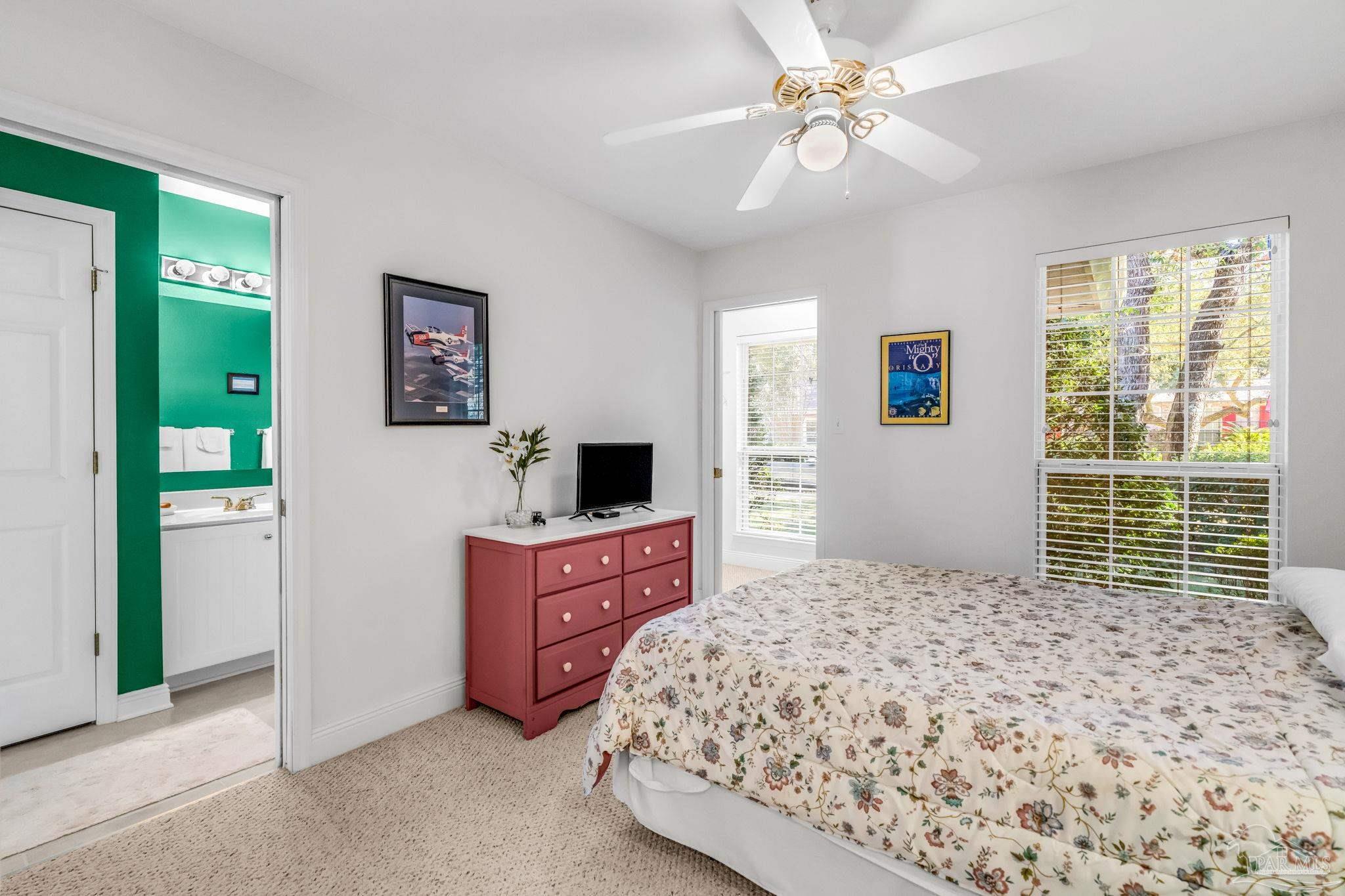 10149 Bittern Drive Pensacola, FL 32507 - Photo 35 of 56 a bedroom with a bed and a chandelier