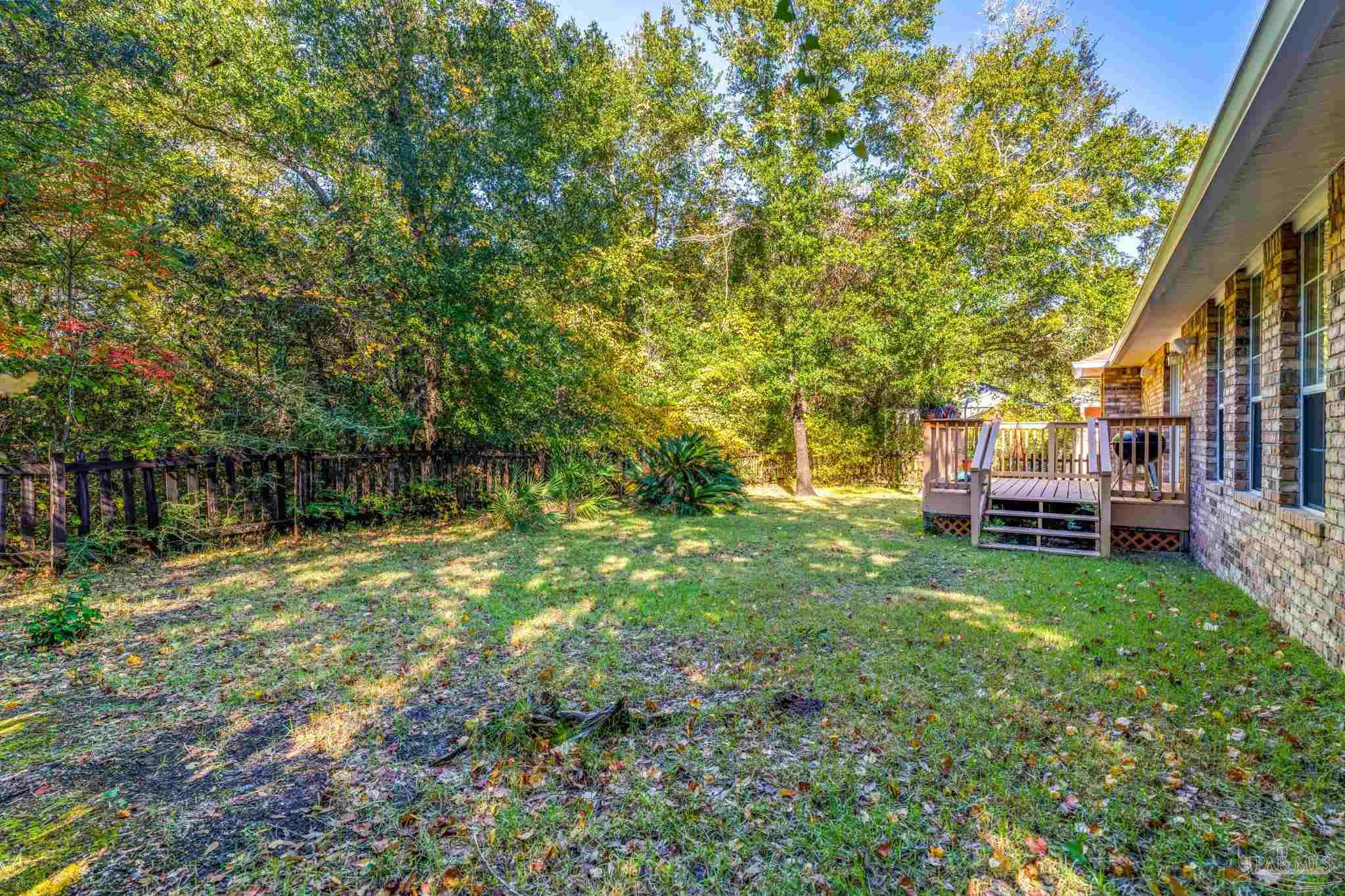 10149 Bittern Drive Pensacola, FL 32507 - Photo 40 of 56 a backyard of a house with lots of green space