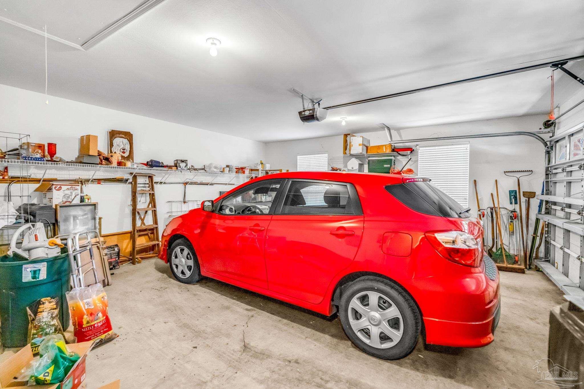 10149 Bittern Drive Pensacola, FL 32507 - Photo 42 of 56 a car is parked in a garage