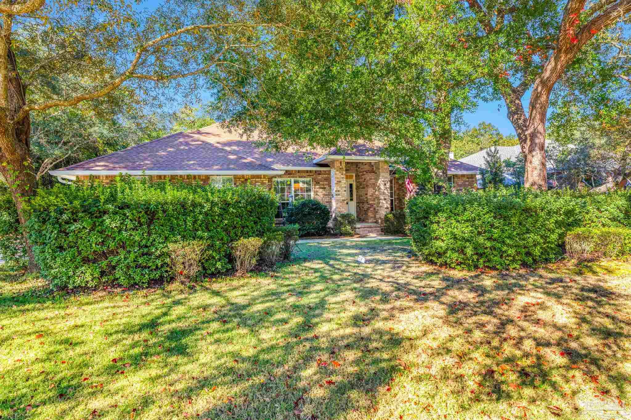 10149 Bittern Drive Pensacola, FL 32507 - Photo 45 of 56 a view of a house with a yard and sitting area