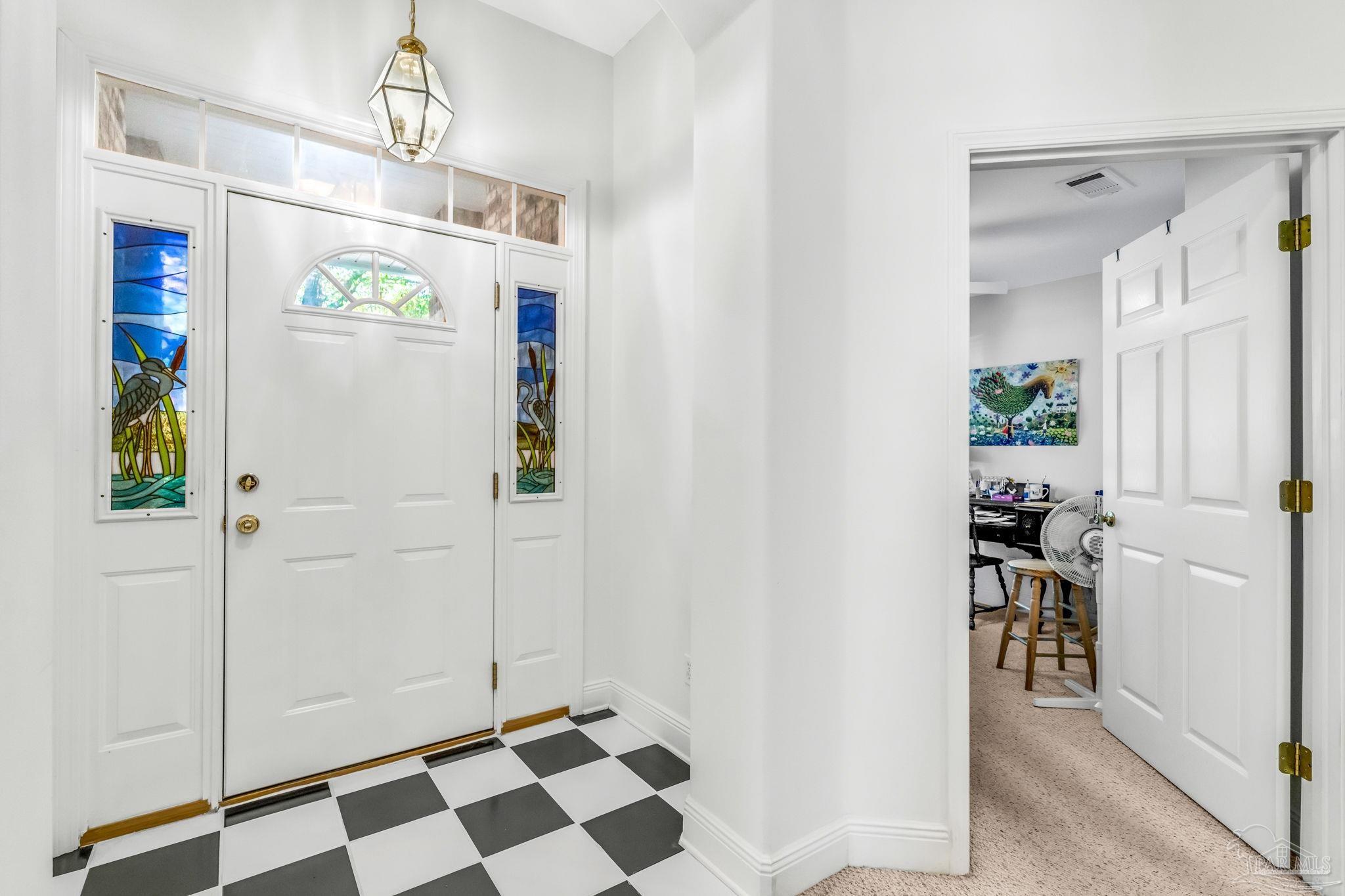 10149 Bittern Drive Pensacola, FL 32507 - Photo 8 of 56 a view of a hallway to a livingroom with furniture and wooden floor
