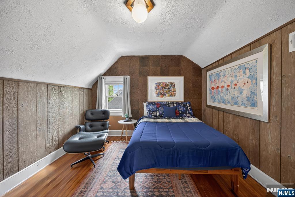 653 Ridgewood Avenue Bloomfield, NJ 07003 - Photo 16 of 27 a bedroom with a bed and wooden floor