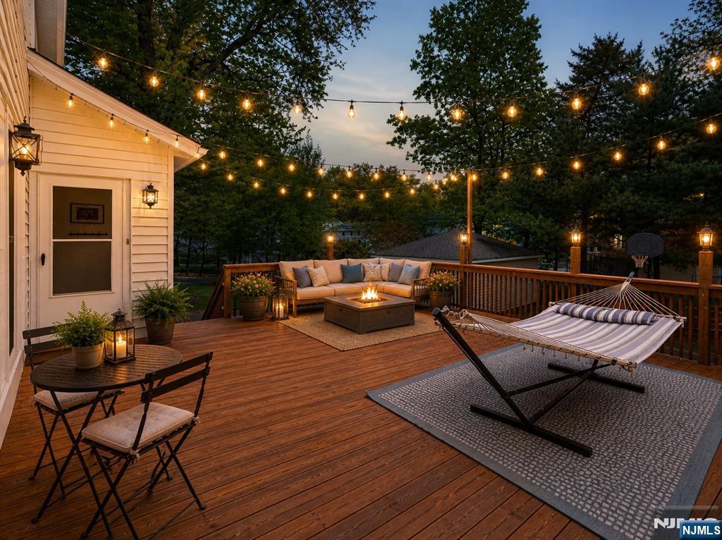 653 Ridgewood Avenue Bloomfield, NJ 07003 - Photo 23 of 27 a roof deck with a table and chairs and potted plants