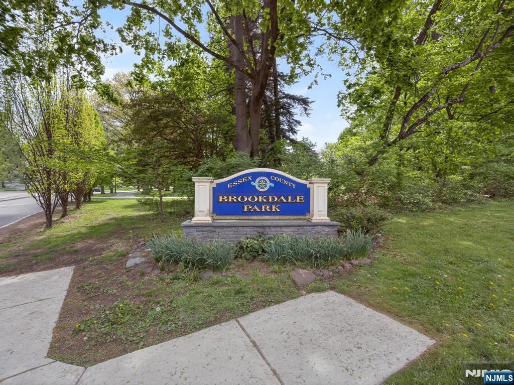 653 Ridgewood Avenue Bloomfield, NJ 07003 - Photo 26 of 27 a sign board with tall trees