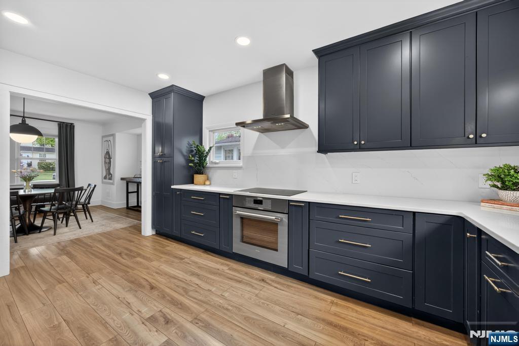 653 Ridgewood Avenue Bloomfield, NJ 07003 - Photo 8 of 27 a kitchen with stainless steel appliances granite countertop a stove a sink and a microwave