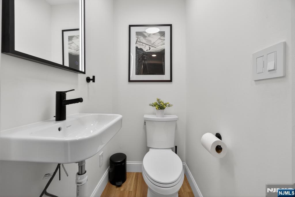 653 Ridgewood Avenue Bloomfield, NJ 07003 - Photo 9 of 27 a bathroom with a toilet a sink and mirror