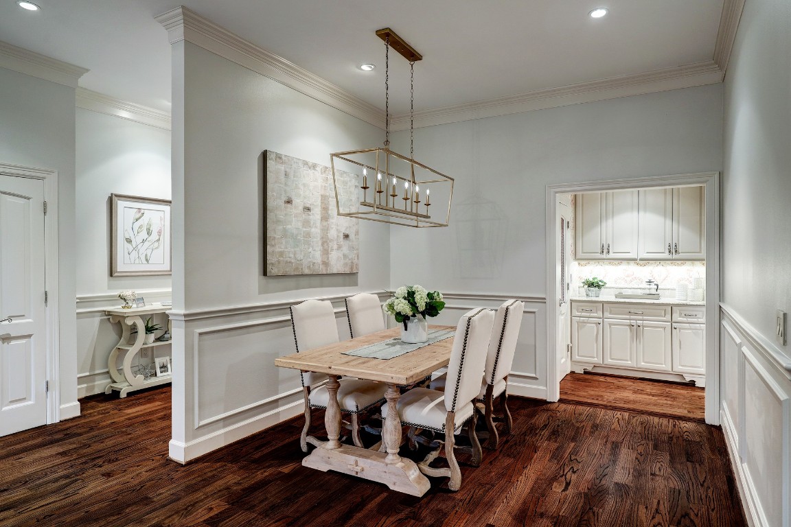 6599 Bayou Glen Road Houston, TX 77057 - Photo 14 of 41 The dining room is open to the family room and the butler's pantry. Featured is a beautiful chandelier, lovely wainscoting, recessed LED lighting and lovely hardwood flooring.
