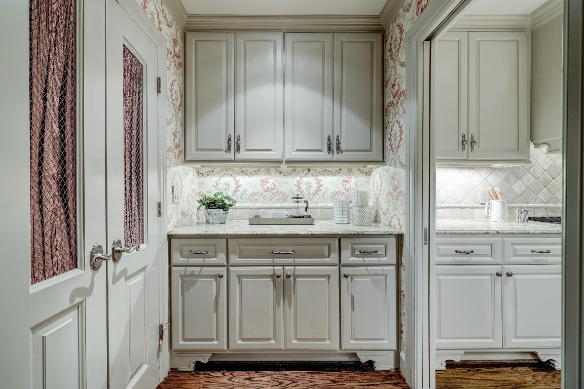 6599 Bayou Glen Road Houston, TX 77057 - Photo 17 of 41 The Butlers area has great storage with custom cabinetry, under counter lighting and decorative hardware, slab counters and decorative tile.