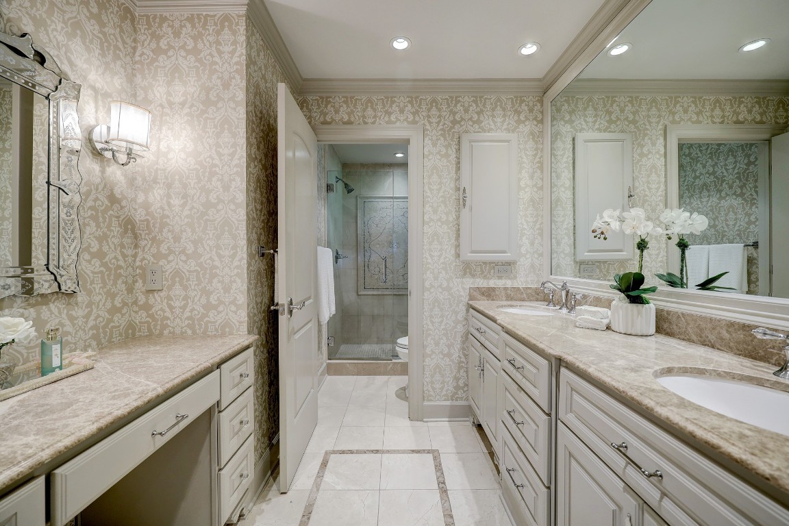 6599 Bayou Glen Road Houston, TX 77057 - Photo 28 of 41 Also featured is a lovely make-up vanity to the left just for her. Decorative finishes include beautiful fixtures and hardware, decorative wall sconces and marble flooring with inlays.